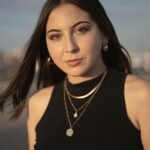 A woman with long hair and a necklace